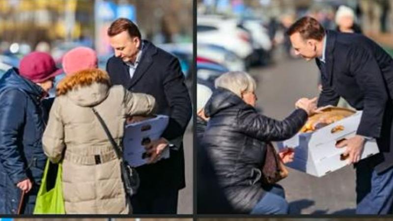 Gibała, z przyklejonym uśmiechem, rozdaje pączki